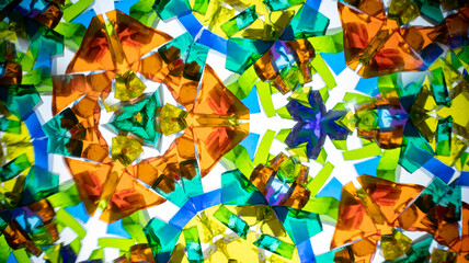 Vibrant macro photography of a natural kaleidoscope pattern, captured on camera. Bright, geometric abstract design with intense colors and light.
