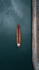 Fototapeta premium Aerial view oil tanker docking harbor industrial calm over deep blue water
