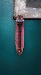 Fototapeta premium Aerial, tanker, oil, harbor, dock, industrial calm scene over turquoise water