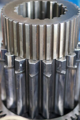 Close-up of a stacked steel component assembly featuring large, prominent straight-cut external...