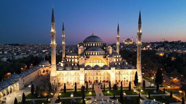 Aerial view of the illuminated sultan ahmed mosque, also known as the blue mosque, in istanbul at twilight with city lights in background