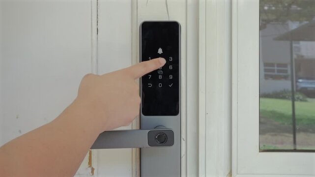 Finger entering home with typing PIN code on smart lock digital keypad to unlock door.