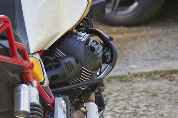 Close up detail of classic vintage motorcycle engine. black metal motor with red frame exudes rugged feeling of power and mechanical beauty for powerful ride