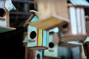 Colorful Wooden Birdhouses Hanging in a Rustic Outdoor Setting