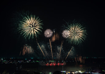 Fototapeta premium Beautiful fireworks with dark sky on the beach of colourful background, Celebration