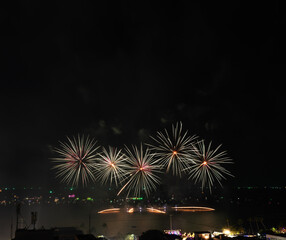Beautiful fireworks with dark sky on the beach of colourful background, Celebration