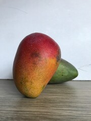 A sweet, fragrant, fiberless mango with smooth flesh. Its green skin turns reddish when ripe, giving it the look of an apple mango.