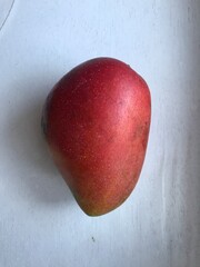A sweet, fragrant, fiberless mango with smooth flesh. Its green skin turns reddish when ripe, giving it the look of an apple mango.
