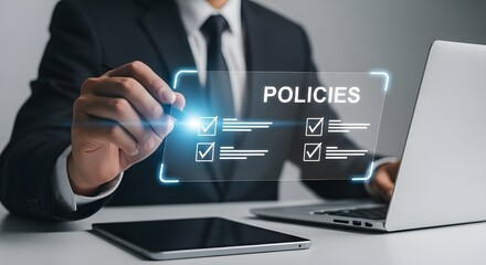 Businessman reviewing and selecting policies on a digital interface with laptop and tablet