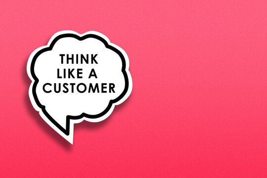 A white speech bubble with the message "Think like customer" on pink background to symbolised understanding customer needs and perspectives, customer-centric mindset