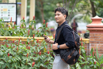 Man walking in a park while using smartphone
