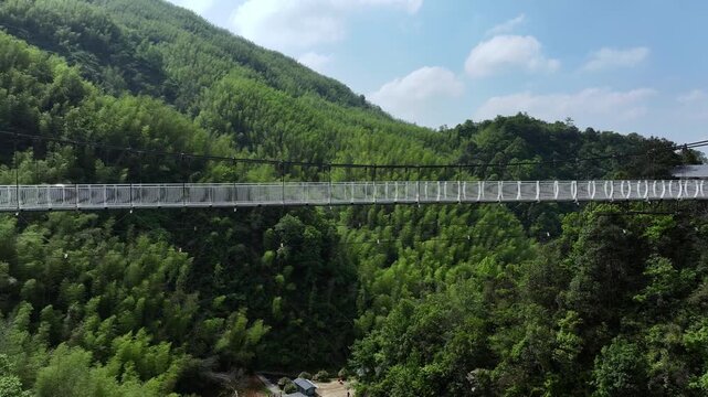 Glass suspension bridge across the valley - Powered by Adobe