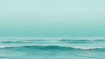 Obraz premium A serene ocean with gentle waves and a clear sky.