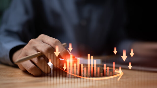 Stacked coins with a falling financial graph and downward arrows illustrate bankruptcy risk, investment loss, declining revenue, economic downturn, and financial instability affecting personal