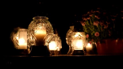Votive Candle Lanterns on Surface of Limestone Grave Tombstone at All Saint Day Evening