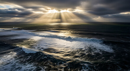 Dramatic Seascape with Rays of Sunlight Breaking Through Dark Clouds Over Turquoise Ocean Waves at Dusk
