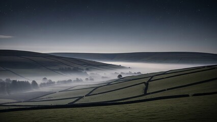 Misty valley landscape with fields, trees, and a distant horizon under a dark sky.