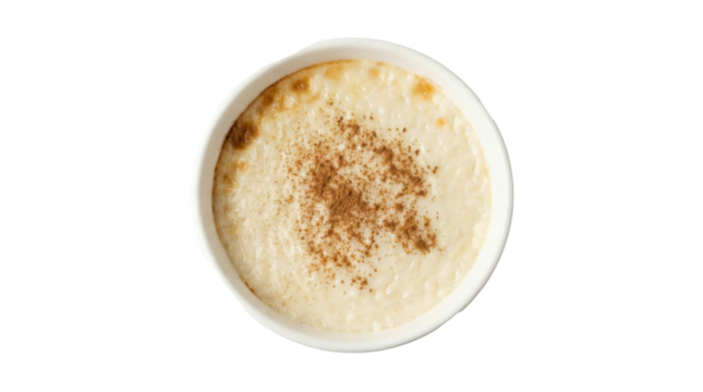 PNG cut out isolated background. A high-angle studio shot of a white ceramic bowl filled with creamy baked rice pudding, also known as Turkish Sutlaç or Arroz con Leche.