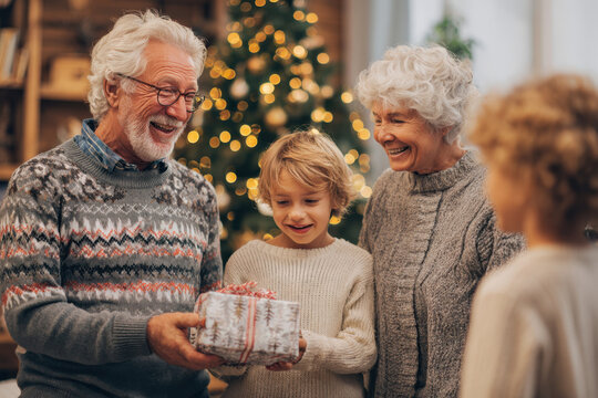 A family of grandparents and grandchildren exchange gifts next to the Christmas tree