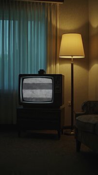 A classic retro television set, displaying an erratic static signal or "snow" on its screen, is the focal point within a dimly lit, atmospheric room. Warm light emanates from an elegant floor lamp on 