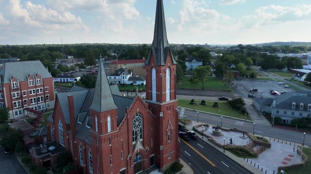 Drone Pulling Away to Reveal Architecture and Cityscape of Immaculate Conception Church in Fort Smith, Arkansas