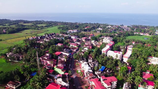 coastal village Fatona with lush greenery and beach at goa. day time, push in shot, drone shot, 4k.