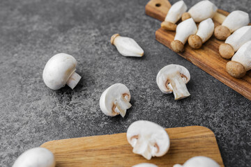 Assorted mushrooms including button, king oyster and shimeji on cutting boards for cooking, recipe or nutrition concept