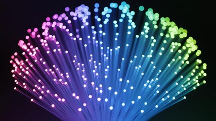 multicolored fiber optic fan glowing with cascading led tips, dark background, neon hues spanning rainbow spectrum, soft bokeh highlights, ambient decorative centerpiece for party and studio lighting, - Powered by Adobe