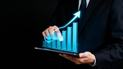 Businessman interacting with a holographic bar chart showing upward growth on a tablet