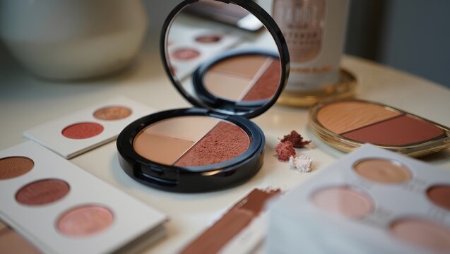 Premium makeup compact array with assorted samples displayed neatly, cosmetics.