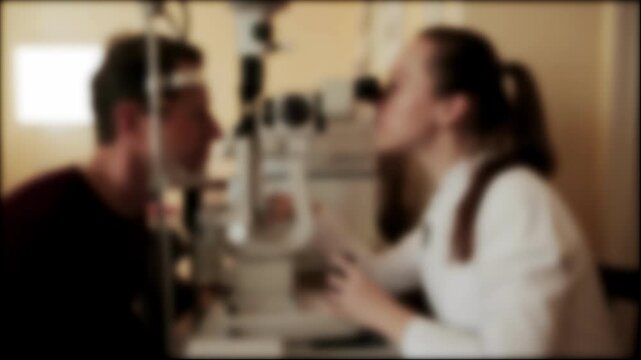 Doctor ophthalmologist checks vision of male patient autorefractometry rays in infrared spectrum with special device. Optical system of eye, background, blurred. Copy space for text