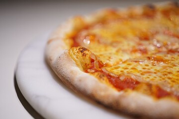 Heart-shaped pizza lace crust edge cheese on plate, appetizing scene for diners