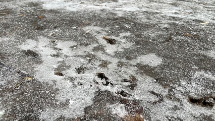 Close-up view of icy surface with intricate patterns and textures, showcasing the beauty of winter frost on a weathered stone background, highlighting nature's artistry