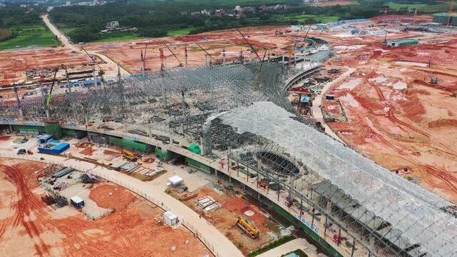 Wuchuan Airport Terminal Construction Site in Zhanjiang China Aerial View with Steel Framework and Cranes