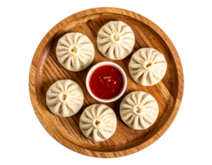 Steamed Chicken Momos Neatly Arranged on Wooden Plate with Chilli Garlic Sauce, Isolated PNG