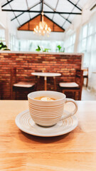 A captivating view of coffee cup in a cafe setting, a warm and inviting atmosphere. The soft focus of the background enhances the foreground, and the color scheme creates a sense of peace