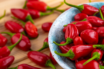Vibrant red jalapeno pepper on a white background with space for text, ideal for food and culinary concepts.Group of ripe red jalapeno peppers .