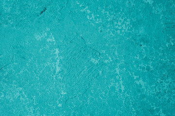 Bright turquoise stucco wall with textured plaster and modern finish