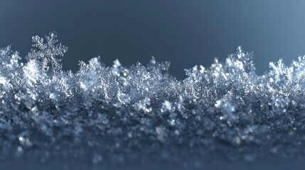 Close up macro view of intricate ice crystals forming delicate frosty patterns on a dark blue background
