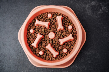 Dog food in pink bowl with bone shaped treat holders