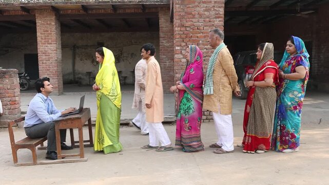Rural indian people standing in a queue to get their documents verified to get benefits of government scheme.