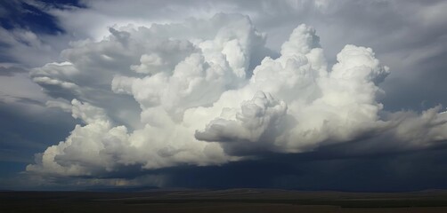 Dense cumulonimbus clouds building ominously over a dark landscape,  sky,   environment