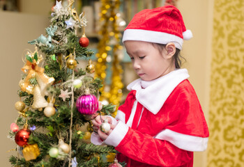 Happy a little girl with Xmas morning in decorated living room.Christmas