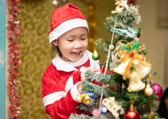 Happy a little girl with Xmas morning in decorated living room.Christmas