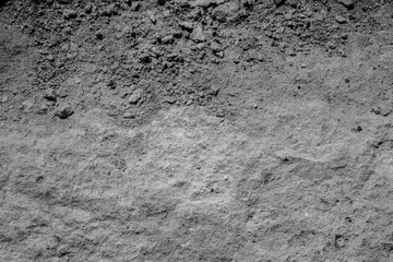 Black-and-white concrete erosion vignette for concept of decay and structural aging