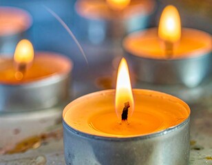 A serene display of flickering tea light candles casting a soft, warm glow, perfect for relaxation