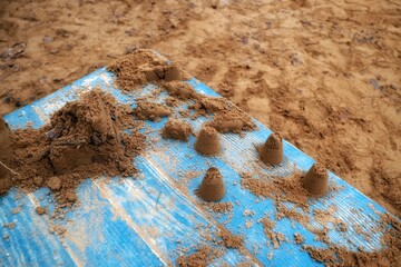 Sand cakes on a blue table in a sandbox