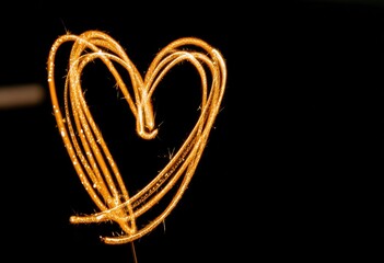 Glowing Heart Shape Against Black Background.