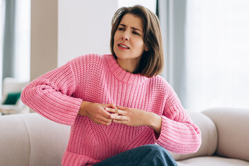 Upset woman feeling finger pain struggling with ring