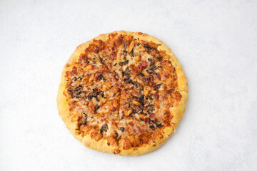  Freshly baked pizza with mushrooms bacon and chicken on light white background ready to eat